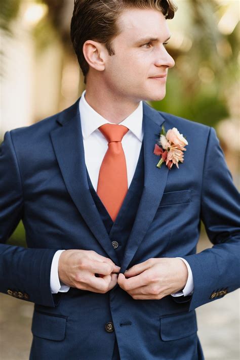 blue suit with terracotta tie.